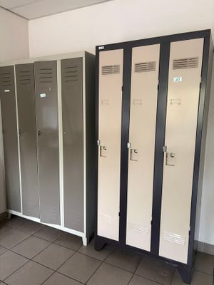 several lockers are lined up in a room with tile flooring