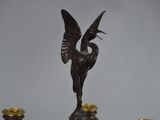 a close up of a statue of a bird on top of a table