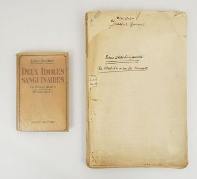 an old book sitting next to an old book on a white surface