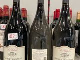 several bottles of wine are lined up on a counter