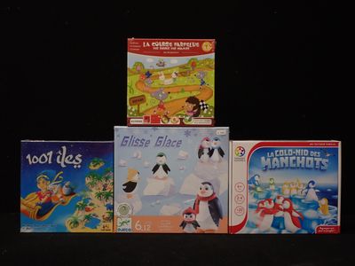 several children ' s board games are stacked on top of each other