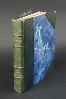 an old green book with a blue cover sitting on top of a table