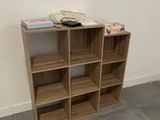 a wooden shelf with several shelves on it in a room