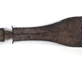 an old knife that is laying on a white surface