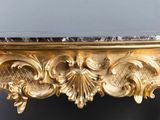 an image of a table with a marble top and a gold leaf decoration