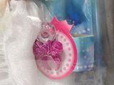 a barbie doll that is wearing a white dress and holding a pink purse
