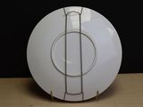 a white plate with a metal ring on it on a table