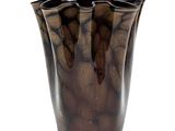a brown vase that is sitting on a white surface