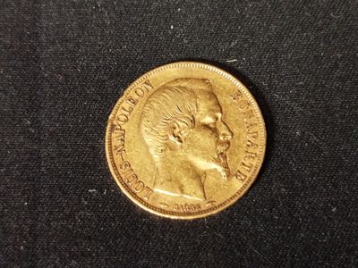 a close up of a coin on a black surface