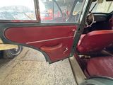 a red and black car that is parked in a lot