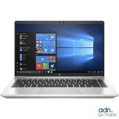 the laptop is open on a white surface with windows on the screen