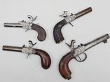 three antique pistols, one of which is a revolver and the other of which is a revolver