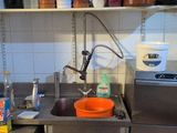 a kitchen with a sink, stove, and dishwasher in it