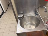 a sink with a drain in the middle of the floor