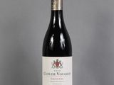 the bottle of red wine is sitting on the table