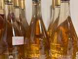 several bottles of wine are lined up on a counter