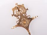 a gold pendant with a picture of a woman on it