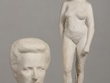 two statues of a woman and a man on a table