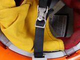 a helmet with a yellow and red jacket on top of it