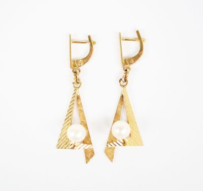 a pair of gold earrings with pearls on a white background