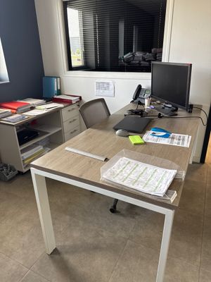 a desk with a computer and a monitor on it