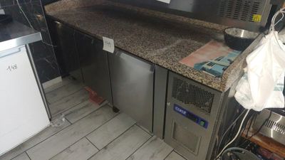 an image of a kitchen with a counter and a refrigerator
