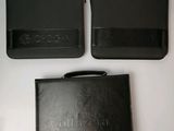 two black wallets sitting next to each other on a table