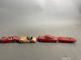 several toy cars are lined up in a row on a gray surface