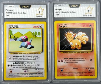 two pokemon cards with different designs on them on a table
