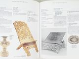 an open book with a picture of a chair and other items