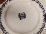 a white plate with blue and yellow flowers on it