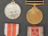several medals and medals are displayed on a black surface
