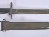 two knives that are laying side by side on a table