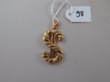 an image of a gold dollar sign ornament hanging from a string