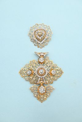 pair of gold and diamond earrings on a blue background