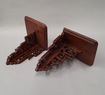 two wooden bookends with intricate carvings on them