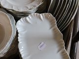 many plates and bowls in a basket on the floor