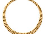 a yellow gold curbet necklace on a white background