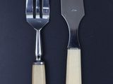 two forks and a knife sitting next to each other