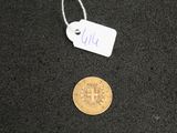 a small coin and a tag on a black surface