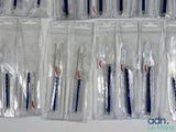 a lot of toothbrushes in the bags on the table