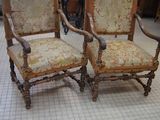 two chairs that are sitting in a room together