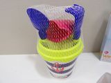 a plastic cup filled with tennis balls and tennis rackets