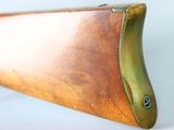 a close up of a rifle on a white surface with a white background