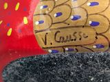 a close up of a red object with a gold design on it