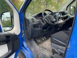 a blue truck with the door open and the driver ' s seat down