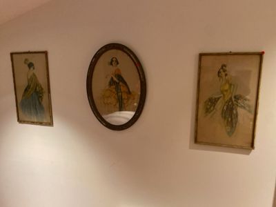 three paintings on the wall above a toilet in a bathroom