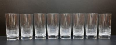 six glasses are lined up in a row on a table
