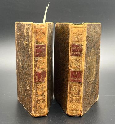 pair of antique leather bound bookends with red and gold bindings