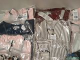 a lot of clothes that are wrapped in plastic bags